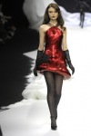 Anna-Maria Urajevskaya on the catwalk in a red dress and black sheer tights