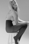 Brooklyn Decker on chair wearing sheer tights