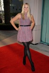 Busy Philipps wearing a short dress and black tights