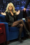Carrie Underwood crossing her legs in black pantyhose