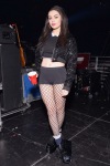 Charli  wearing shorts and fishnet tights