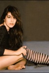 Charlotte Gainsbourg putting on her striped stockings