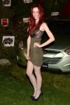 Chloe Dykstra in a green dress and high heels