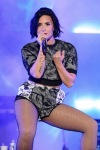 Demi Lovato on stage in fishnet tights
