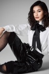Gemma Chan wearing sheer stockings and sandals