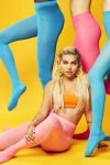 Hayley Kiyoko posing in and with colored tights