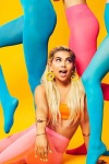 Hayley Kiyoko posing in and with colored tights