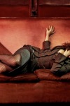 Helena Bonham Carter laying wearing fishnet stockings