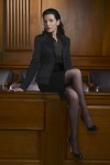 Julianna Margulies with crossed legs in black tights
