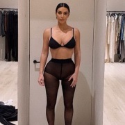 Kim Kardashian wearing black sheer tights, at home