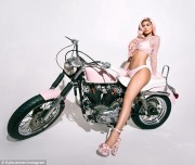 Kylie Jenner posing her legs on a motor bike