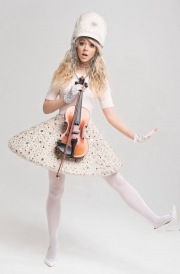 Lindsey Stirling with a white uniform and stockings