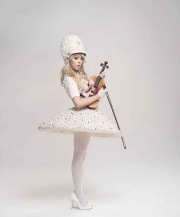 Lindsey Stirling with a white uniform and stockings