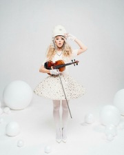 Lindsey Stirling with a white uniform and stockings