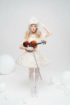 Lindsey Stirling with a white uniform and stockings