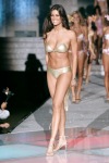 Manuela Arcuri wearing golden bikini and high heel sandals