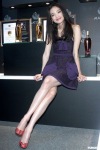 Shu Qi with crossed legs wearing a short dress