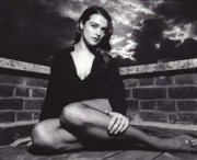 Rachel Weisz sitting in fishnet pantyhose