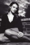 Rachel Weisz sitting in fishnet pantyhose