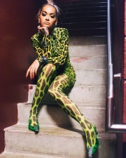 Rita Ora wearing a nylon anymalier tight dress