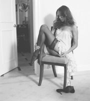 Zoe Saldana's wearing black stockings and suspenders